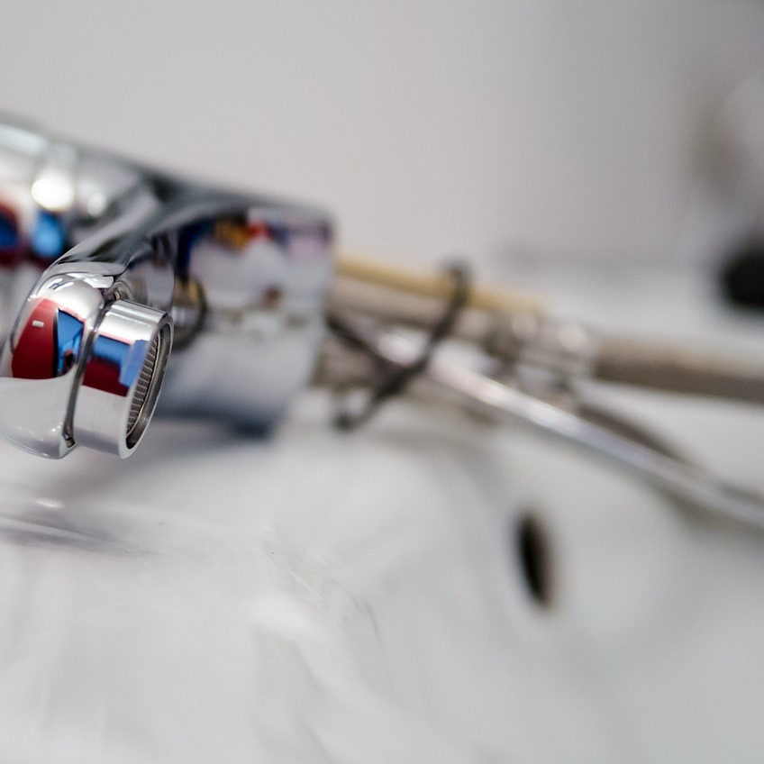 plumber fixing sink wrench